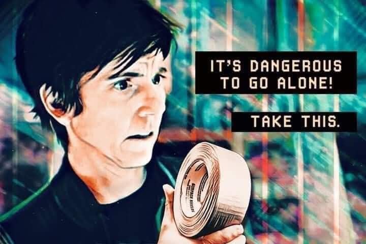 This meme features a screenshot from the 2005 movie "The Hitchhiker's Guide to the Galaxy" with a character named Marvin, a paranoid android, holding a towel. The text overlayed on the image reads: "It's not just a towel, it's a metaphor for the absurdity of life."